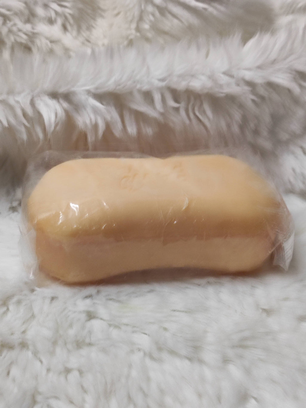 Rich Pure Double Action Clarifying Soap in packaging on a fluffy background, part of the double action clarifying skincare set.